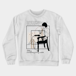 Sitting and looking at my mobile version 7 Crewneck Sweatshirt